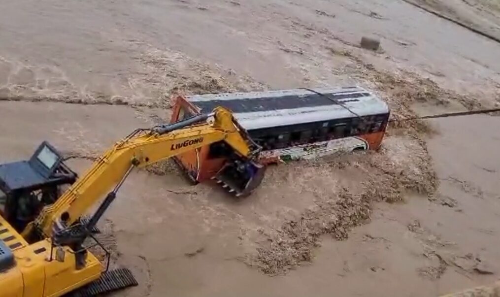Bus carrying passengers gets stuck after river overflows, rescued by officials in northern India